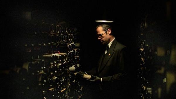 A sommelier of Paris restaurant La Tour d'Argent holds a bottle of wine in the restaurant's cellar in central Paris on September 2, 2020.